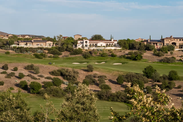The country inland, homes and the buildings in Santaluz, with people walking.