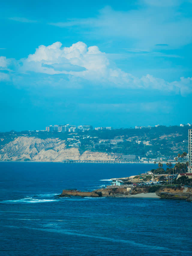 Aerial view of the cliffs, the pier and the ocean at La Jolla Cove.