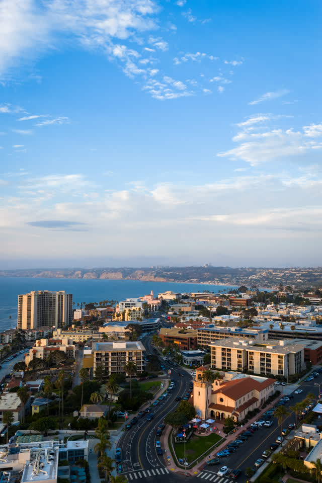 Aerial view of the downtown streets, palm trees and the ocean at La Jolla Cove.
