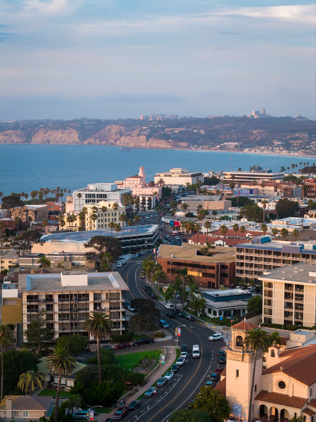 Aerial view of the downtown streets, palm trees and the ocean at La Jolla Cove.