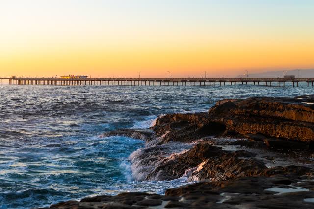 The cliffs, the surf and the pier in Ocean Beach.