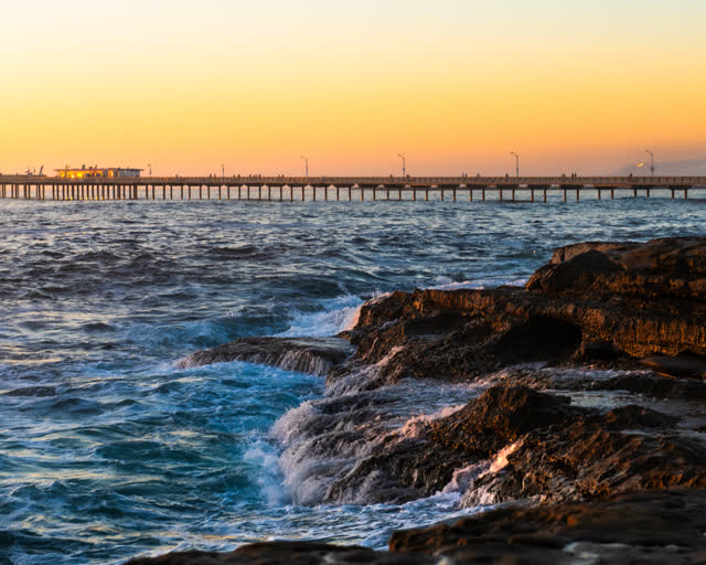 The cliffs, the surf and the pier in Ocean Beach.