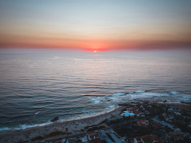 Aerial view of the beach, the surf and palm trees at Windansea.