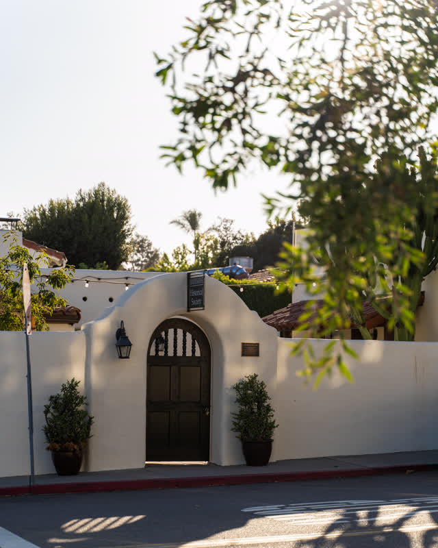 A residential street, palm trees and the buildings at Covenant.