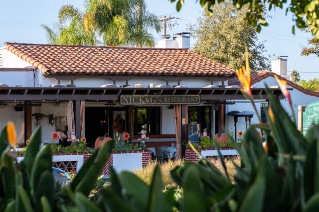 The downtown streets, palm trees and homes at Covenant, with people eating outside.