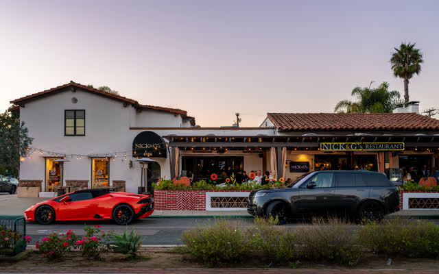 The downtown streets, palm trees and homes at Covenant, with people eating outside.