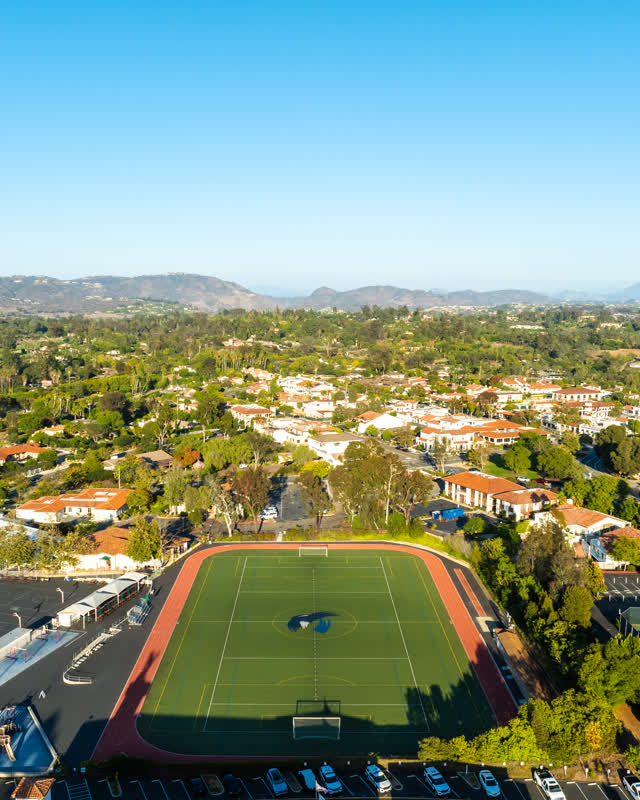 Aerial view of a residential street, homes and traffic at Covenant.