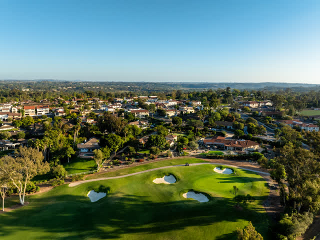 Aerial view of a residential street, homes and open country at Covenant.