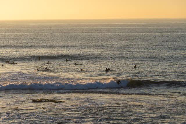 The beach, the surf and the ocean at Windansea, with surfers out.