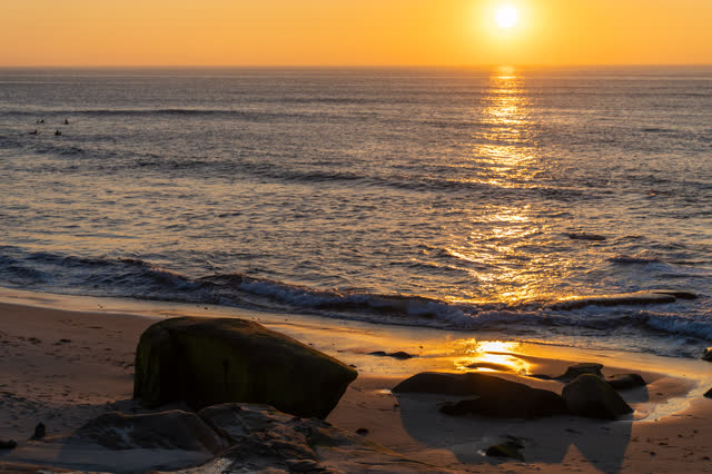 The beach, the surf and the ocean at Windansea, with surfers out.