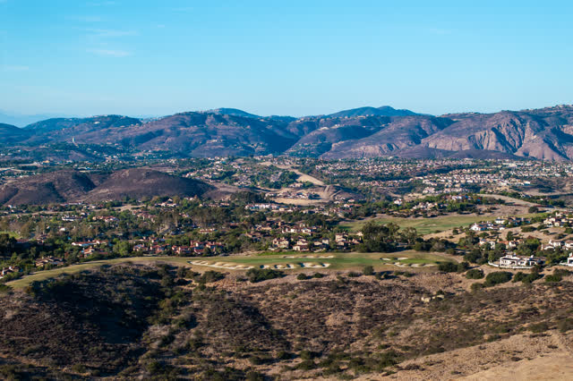 Aerial view of the country inland, homes and open country in Santaluz.