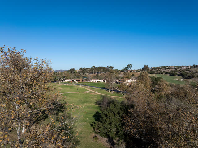Low aerial view of the country inland, homes and the buildings in Santaluz.