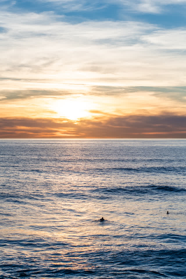 The beach, the surf and the ocean at Windansea, with swimmers in the water.