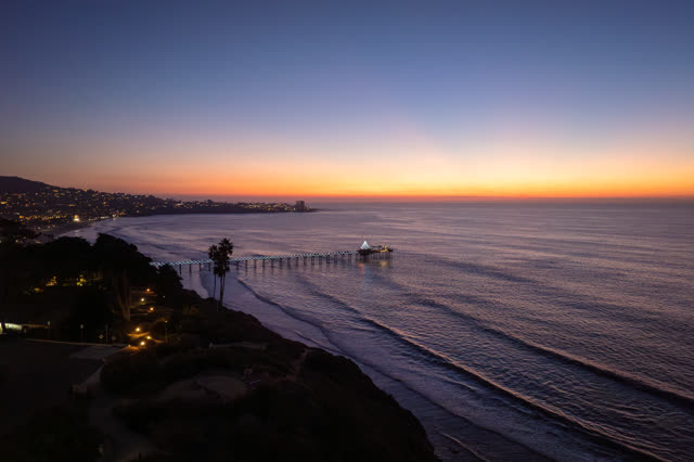 Aerial view of the beach, the pier and palm trees at La Jolla Shores.