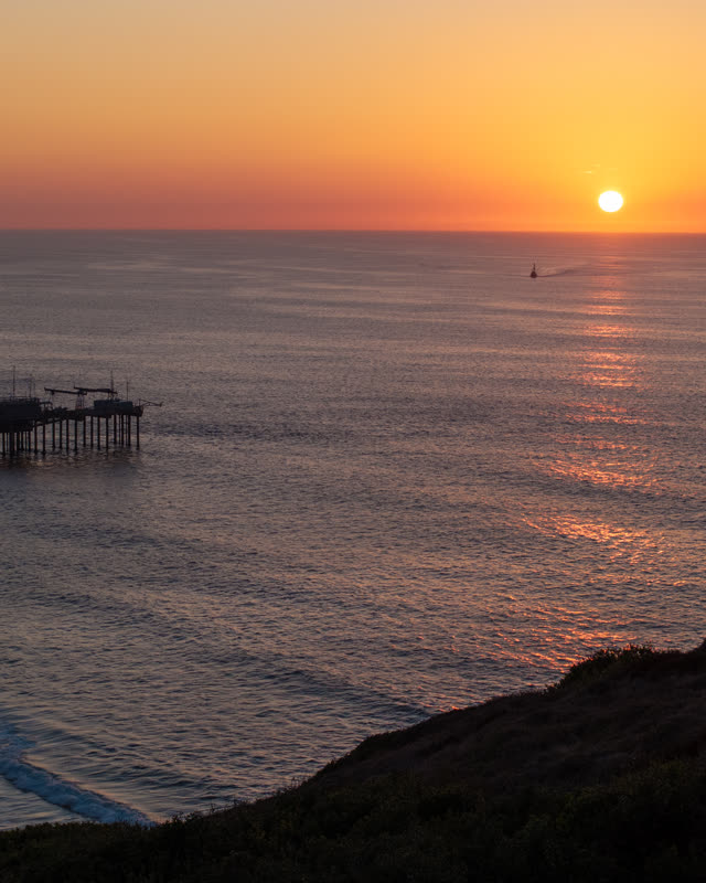 Elevated view of the cliffs, the pier and the ocean at La Jolla Shores.
