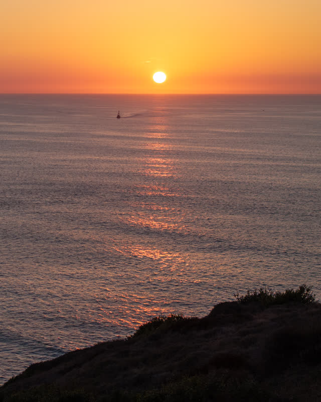 Elevated view of the cliffs, boats and the ocean at La Jolla Shores.