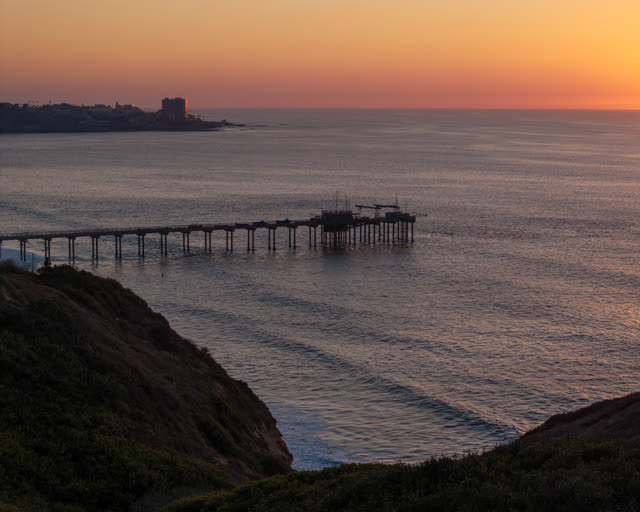 Elevated view of the cliffs, the pier and the ocean at La Jolla Shores.