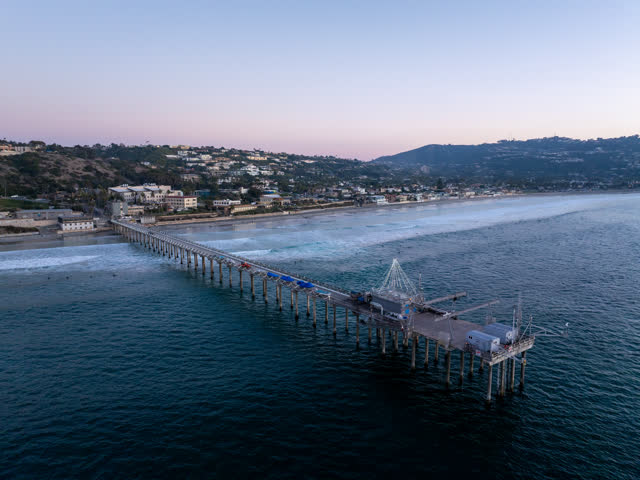 Aerial view of the beach, the surf and the pier at La Jolla Shores.
