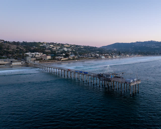 Aerial view of the beach, the surf and the pier at La Jolla Shores.