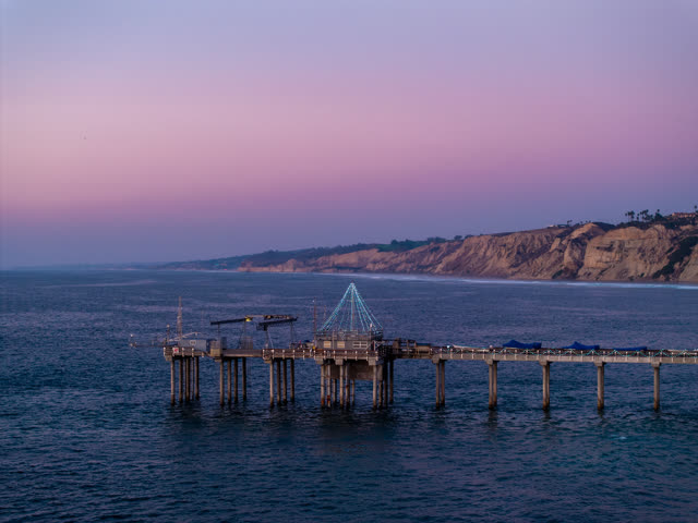 Low aerial view of the beach, the pier and the ocean at La Jolla Shores.