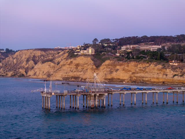 Low aerial view of the beach, the pier and the ocean at La Jolla Shores.
