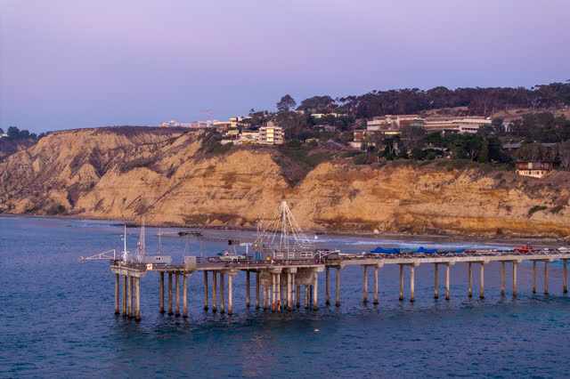 Low aerial view of the beach, the pier and the ocean at La Jolla Shores.