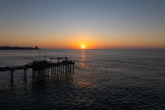 Low aerial view of the beach, the pier and the ocean at La Jolla Shores.