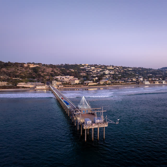 Aerial view of the beach, the surf and the pier at La Jolla Shores.