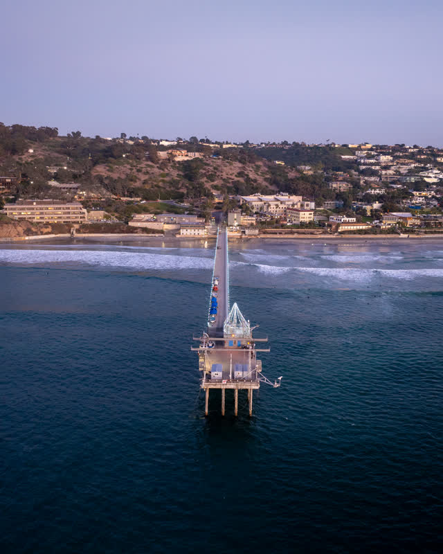 Aerial view of the beach, the surf and the pier at La Jolla Shores.