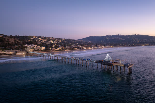 Aerial view of the beach, the surf and the pier at La Jolla Shores.
