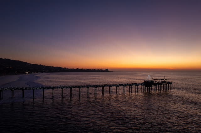Low aerial view of the beach, the pier and the ocean at La Jolla Shores.