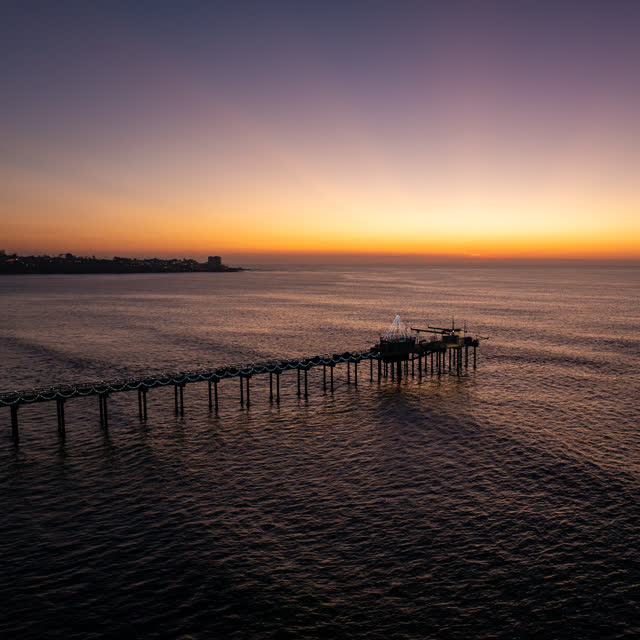 Low aerial view of the beach, the pier and the ocean at La Jolla Shores.