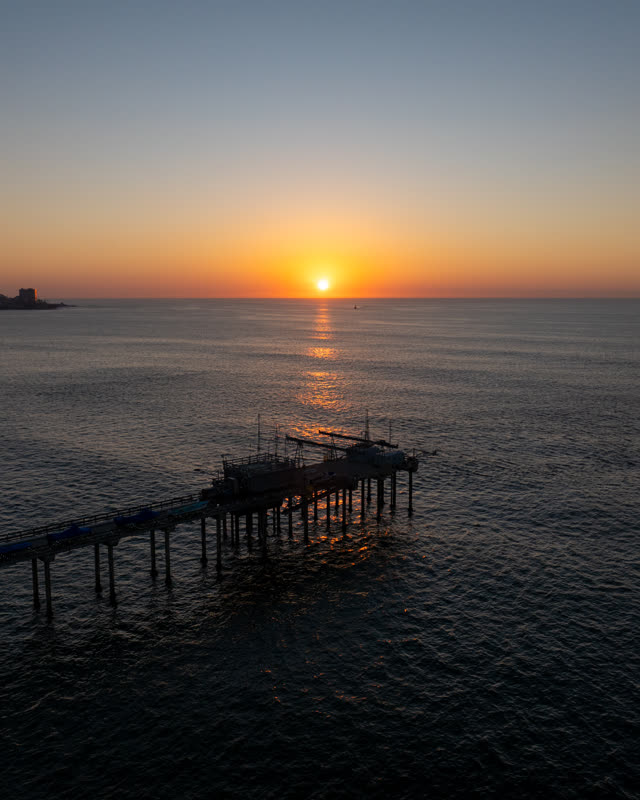 Low aerial view of the beach, the pier and the ocean at La Jolla Shores.