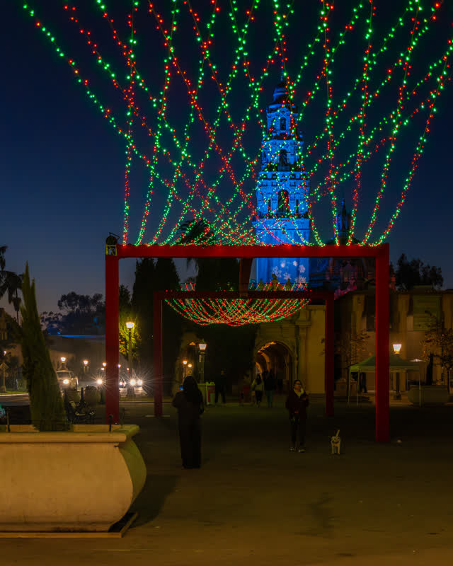 A park, wildlife and the buildings in Balboa Park, with people walking.