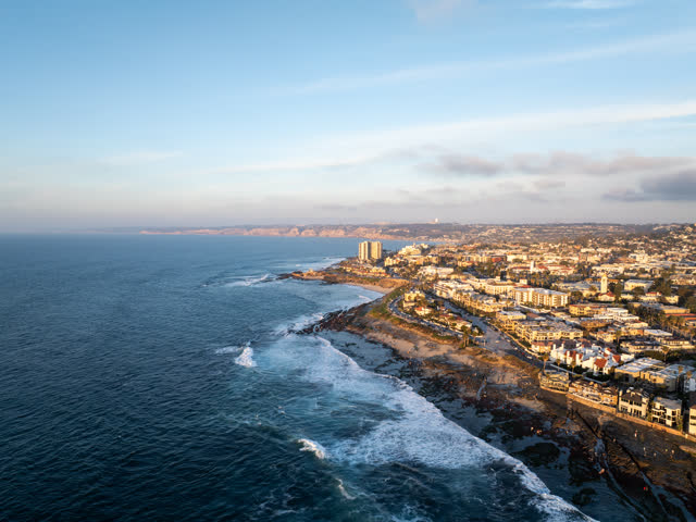 Aerial view of the cliffs, the surf and the ocean at La Jolla Cove.