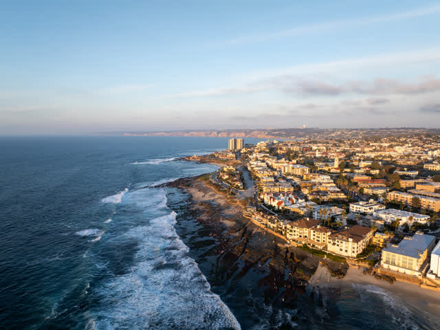Aerial view of the cliffs, the surf and the ocean at La Jolla Cove.