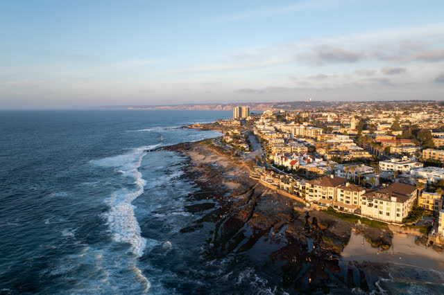 Aerial view of the cliffs, the surf and the ocean at La Jolla Cove.