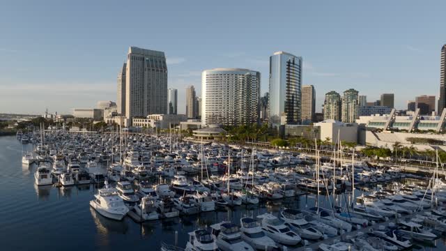 Low aerial view of the harbor, the skyline and boats at Marina, with boats out.