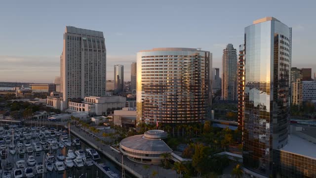 Low aerial view of the downtown streets, the skyline and boats at Marina.