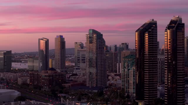 Low aerial view of the downtown streets, the skyline and the buildings at Marina.