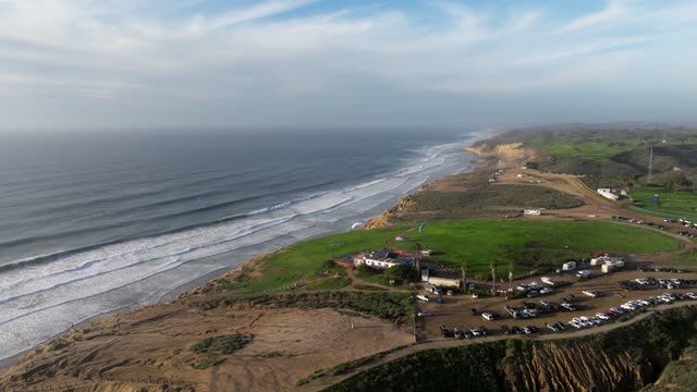 Aerial view of the cliffs, the surf and the ocean at Black’s Beach.