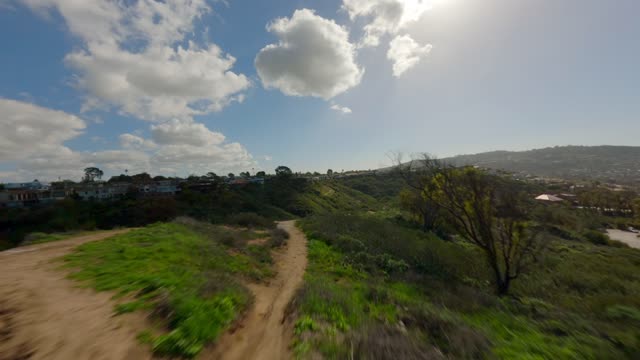 Low aerial view of the country inland, homes and open country at La Jolla Shores.