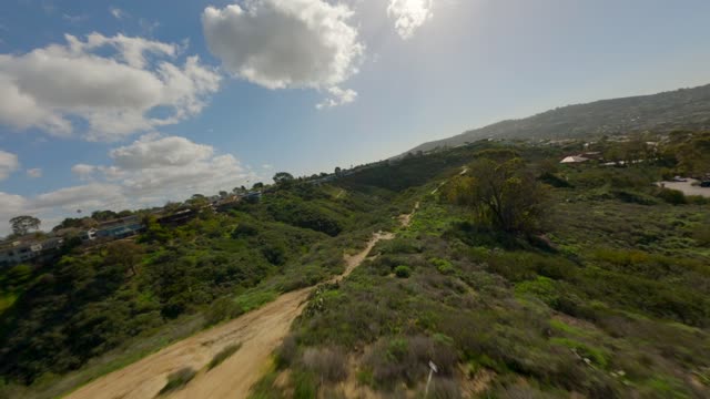 Low aerial view of the country inland, homes and open country at La Jolla Shores.