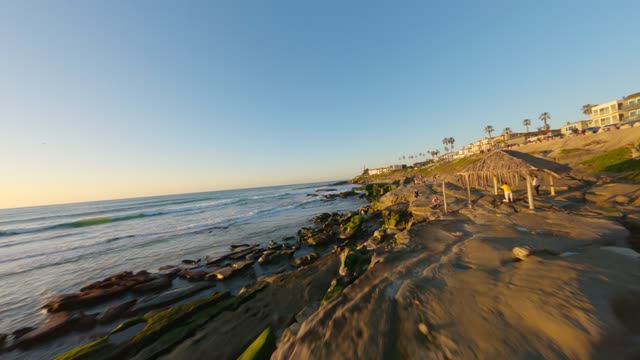Flying low above the beach and rocks at Windansea in La Jolla