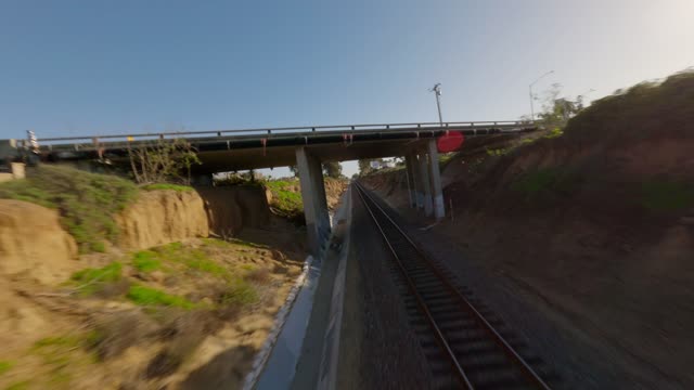 Low aerial view of the country inland, the bridge and traffic at Leucadia.