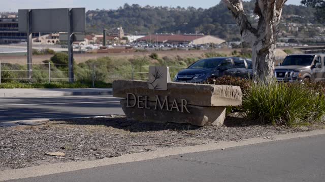 A residential street, homes and traffic in Del Mar.