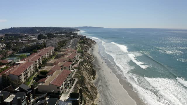 Aerial view of the cliffs, the surf and the ocean in Solana Beach.