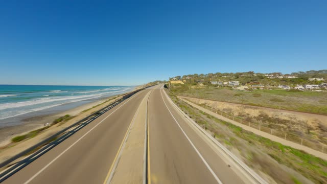 Low aerial view of the beach, the surf and the ocean at Torrey Pines.