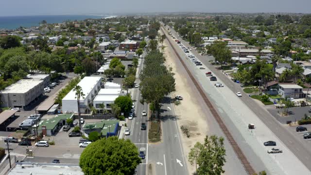 Aerial view of a residential street, palm trees and the ocean at Leucadia.