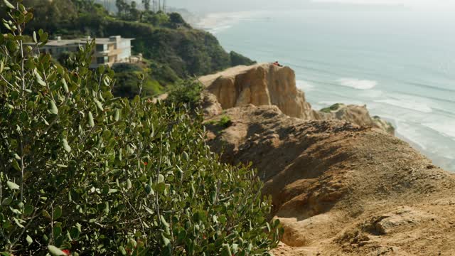 Elevated view of the cliffs, the ocean and homes at Black’s Beach.